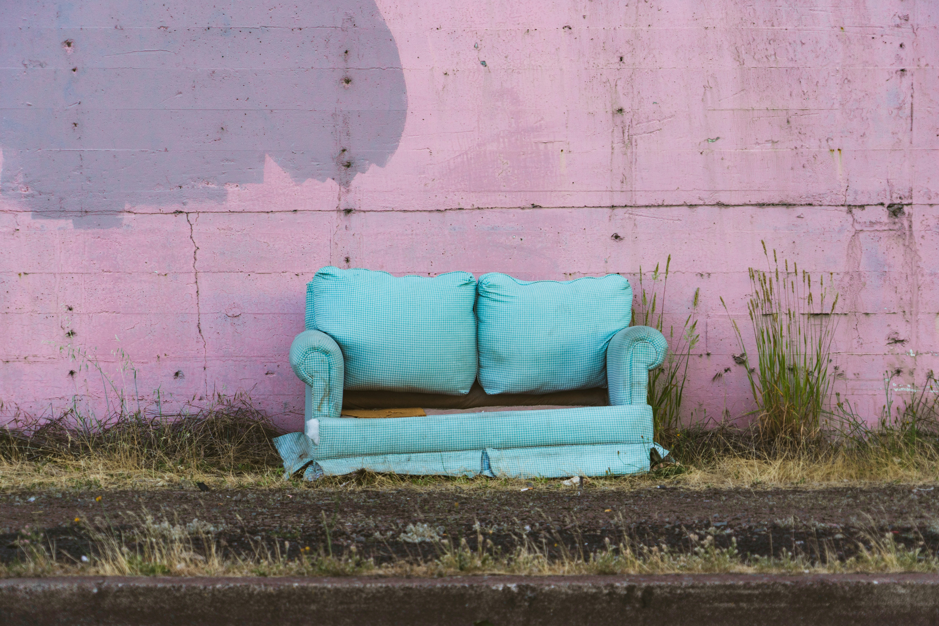 Teal couch ready to be hauled away